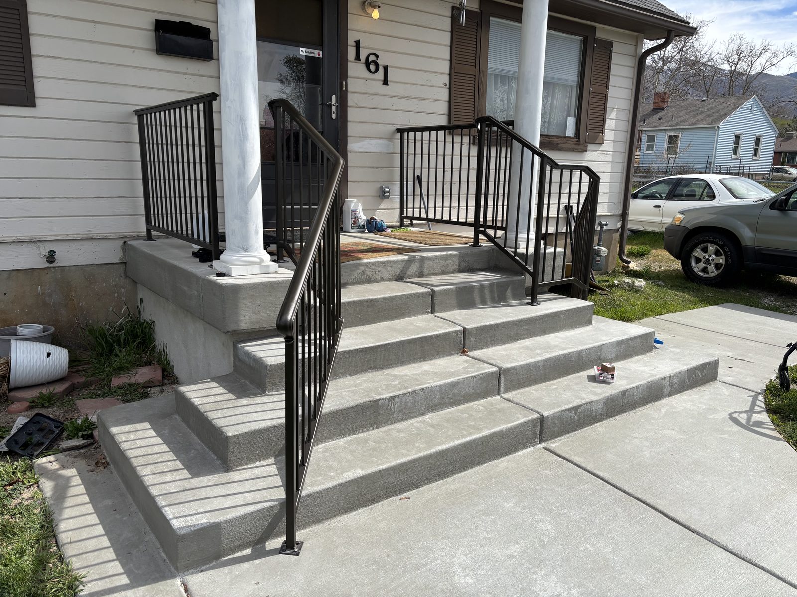 Bronze wrought-iron porch handrails on craftsman bungalow