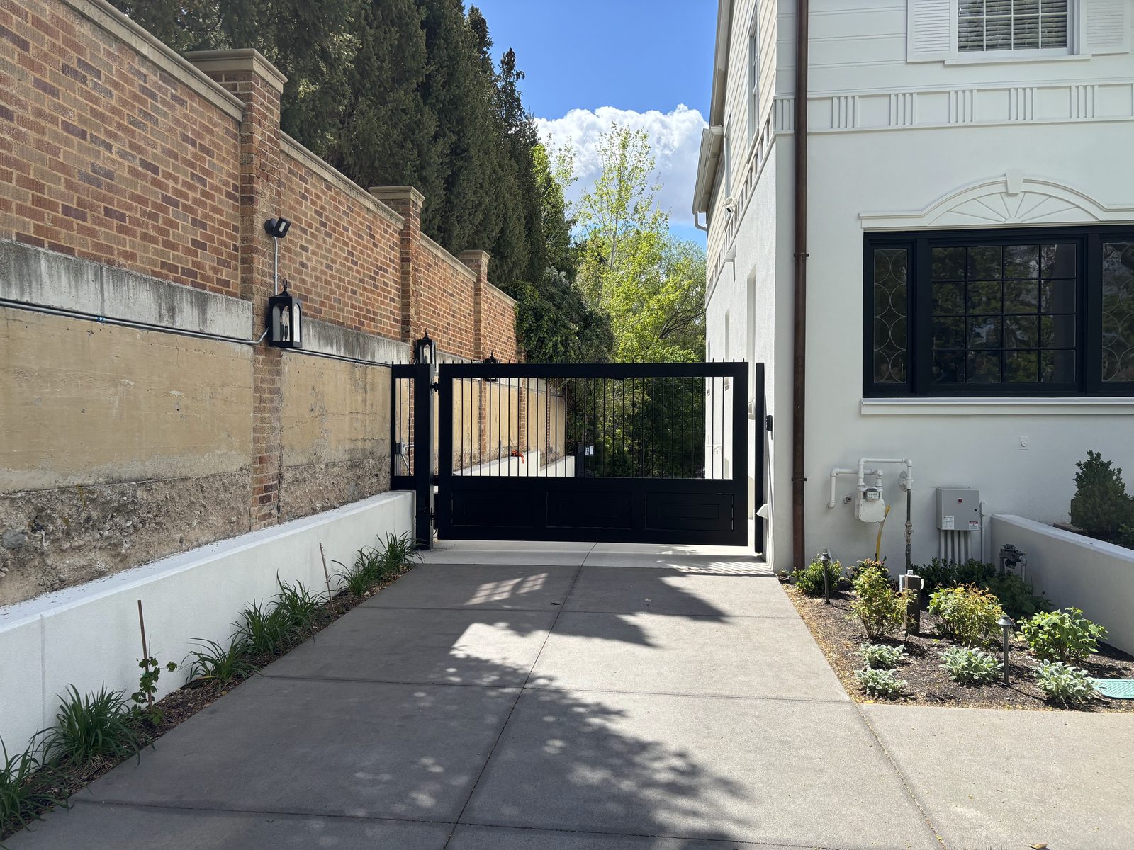 Custom black steel driveway gate fabricated and installed by MTJ Welding in Salt Lake City
